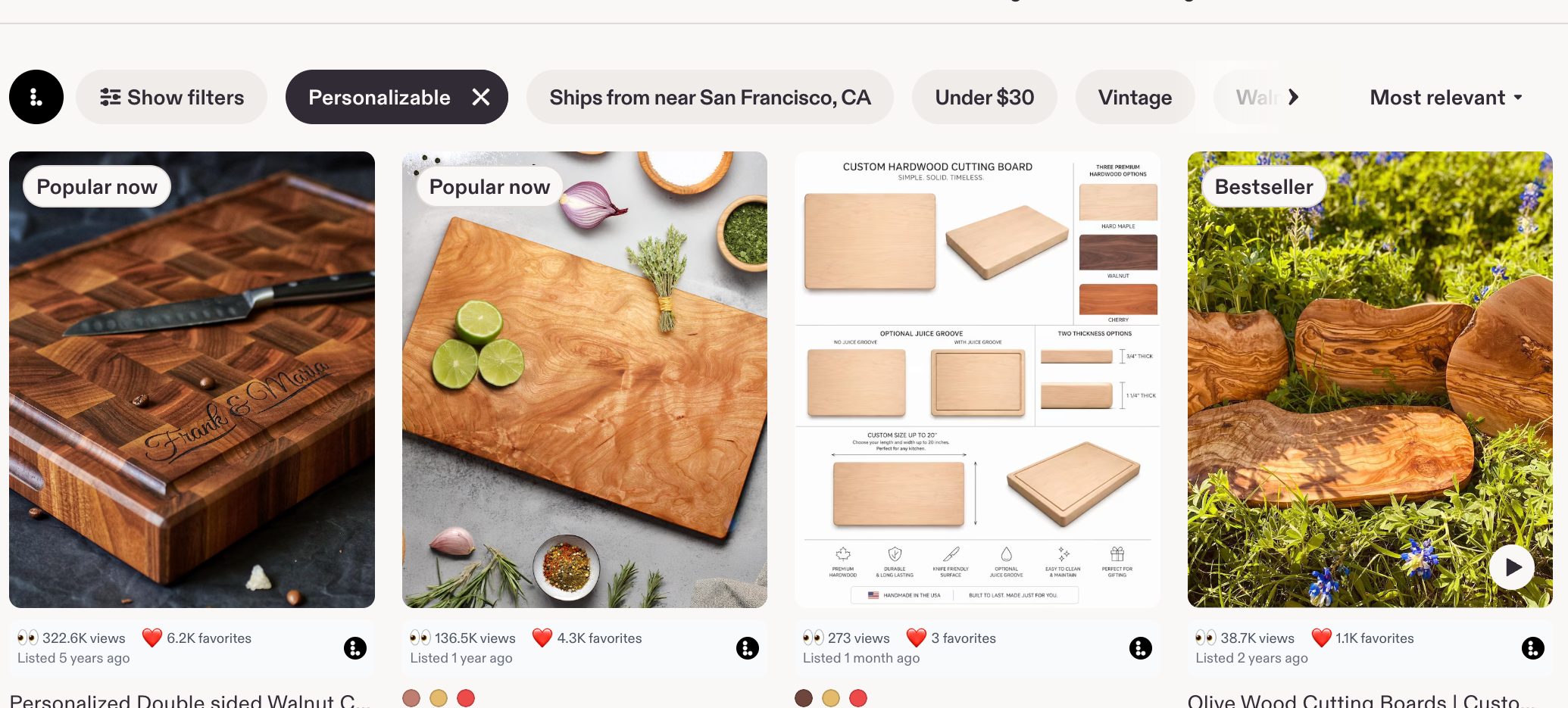 A row of Etsy cutting board listings with the Listadum browser extension showing views and favorites on each card.